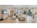 Comfortable living room with tile flooring, light-colored furniture, and bright natural light at 4524 Baltry Ct, Bradenton, FL 34211