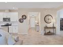 An open-concept living room area with wood-look tile flooring and neutral paint throughout at 4524 Baltry Ct, Bradenton, FL 34211