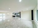 Spacious living room featuring gleaming tile floors, neutral walls, and recessed lighting at 4616 34Th E Ave, Bradenton, FL 34208