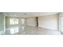 Open living room featuring tile floors, a large window, and a bright front door at 4616 34Th E Ave, Bradenton, FL 34208