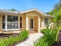 Inviting front entrance showcasing a well-manicured garden and a tiled front porch at 4830 Estrada De Costa, Sarasota, FL 34242