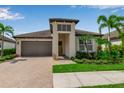 Charming one-story home boasts lush landscaping, paver driveway, and a welcoming entrance with a stylish front door at 4869 Antrim Dr, Sarasota, FL 34240