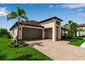 Beautiful single-story home with a paver driveway, two-car garage, and professionally landscaped front yard at 4869 Antrim Dr, Sarasota, FL 34240