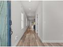 Bright hallway featuring hardwood floors and natural light, leading to the living spaces at 4920 69Th N St, St Petersburg, FL 33709