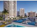 Modern high-rise condo building overlooking a marina and pool at 555 Quay Cmn # 1801, Sarasota, FL 34236