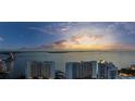 Sweeping views of the condo high-rise and surrounding coastline at sunset at 555 Quay Cmn # 1801, Sarasota, FL 34236