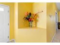 Bright and welcoming entryway featuring a decorative flower arrangement on a built-in shelf at 5609 Spanish Point Ct, Palmetto, FL 34221