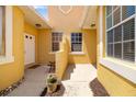 Inviting front porch with a bench and potted flowers, creating a cozy and welcoming entrance at 5609 Spanish Point Ct, Palmetto, FL 34221