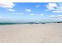 Wide sandy beach with clear skies at 5806 Gulf Dr # 201, Holmes Beach, FL 34217