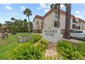 Waters Edge condos feature tropical landscaping, mature palms, and beach access at 5806 Gulf Dr # 201, Holmes Beach, FL 34217