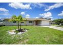 Beautiful home with well-manicured lawn, landscaped garden, and a two-car garage at 590 Ridgewood Nw St, Port Charlotte, FL 33952