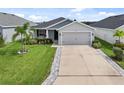 Attractive single-story home with a two-car garage, highlighting a neat lawn and pleasant landscaping in a serene neighborhood at 5958 164Th E Ave, Parrish, FL 34219