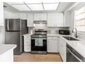 Bright kitchen with stainless steel appliances, white cabinetry, and quartz countertops at 643 Park Cir, Bradenton, FL 34207