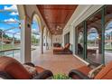 Covered outdoor patio with chairs and view of pool at 7025 Saddle Creek Cir, Sarasota, FL 34241
