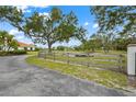 A serene pond sits next to the home beyond a lovely wood fence at 7025 Saddle Creek Cir, Sarasota, FL 34241