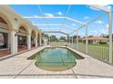 A large screened-in pool is surrounded by a brick patio at 7025 Saddle Creek Cir, Sarasota, FL 34241