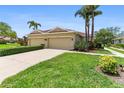 Charming villa with attached two-car garage and a well-manicured front yard with vibrant green grass at 7403 Hamilton Rd, Bradenton, FL 34209