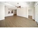 Spacious living room features wood floors, a modern ceiling fan, and an open layout at 7403 Hamilton Rd, Bradenton, FL 34209