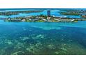 Stunning aerial view of waterfront condos surrounded by crystal-clear turquoise waters at 767 John Ringling Blvd # 25, Sarasota, FL 34236