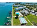 Aerial view showcasing a community pool, shuffleboard, boat docks and well maintained landscaping at 767 John Ringling Blvd # 25, Sarasota, FL 34236