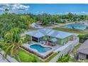 Aerial view of the property showcasing the pool, patio, landscaping, and fencing at 7727 9Th Avenue Nw Dr, Bradenton, FL 34209