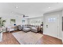 Spacious living room with hardwood floors, large sectional sofa, and plenty of natural light at 7727 9Th Avenue Nw Dr, Bradenton, FL 34209