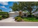 Attractive single-story home featuring an attached garage and beautiful mature landscaping at 7952 Hampton Ct, University Park, FL 34201