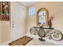 Bright entryway featuring a decorative mirror, console table, tile flooring, and a white front door at 843 Molly Cir, Sarasota, FL 34232