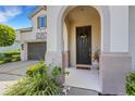 Inviting front porch with decorative wreath and stylish accents, leading to the front door and two-car garage at 843 Molly Cir, Sarasota, FL 34232