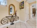 Elegant hallway with tile flooring, decorative mirror, console table, and access to various rooms at 843 Molly Cir, Sarasota, FL 34232