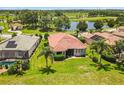 Backyard aerial view with green grass and mature landscaping at 8906 Stone Harbour Loop, Bradenton, FL 34212