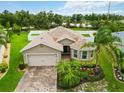 Inviting home features a well-manicured lawn, mature landscaping, and brick paver driveway at 8937 Excelsior Loop, Venice, FL 34293