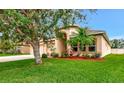 Manicured lawn and landscaping enhance this lovely home's curb appeal at 11324 77Th E St, Parrish, FL 34219