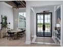 Elegant foyer with double doors and a view into the dining room at 1162 Blue Shell Loop, Sarasota, FL 34240