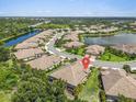 Community aerial view showing residences, streetscape, and water features in this beautiful neighborhood at 1301 Backspin Dr, Englewood, FL 34223