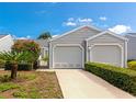 Charming home with two-car garage, well-manicured lawn, and lush landscaping at 1316 Perico Point Cir, Bradenton, FL 34209