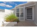 Charming front entrance with gray siding, neutral exterior paint, and well-maintained landscaping at 1316 Perico Point Cir, Bradenton, FL 34209