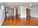 Bright living room featuring hardwood floors, a ceiling fan, fresh paint, and easy access to the kitchen at 1354 22Nd St, Sarasota, FL 34234