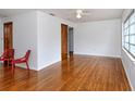 Spacious living room featuring hardwood floors, neutral walls, and ample natural light from the large windows at 1354 22Nd St, Sarasota, FL 34234