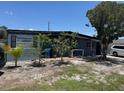 Single-story home showing mature landscaping, complete with exterior shutters at 1506 S 78Th S St, Tampa, FL 33619