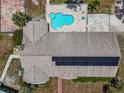 Aerial view of the home's roof with solar panels, pool, hot tub, and patio area at 15440 County Road 675, Parrish, FL 34219