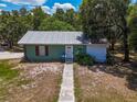 Charming exterior view of a detached home on the property with green siding at 15440 County Road 675, Parrish, FL 34219