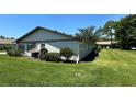 A lush green lawn surrounds the rear exterior of the property at 1553 Stewart Dr # 513, Sarasota, FL 34232
