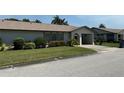 Well-maintained one story villa with lush green lawn and landscaping at 1553 Stewart Dr # 513, Sarasota, FL 34232