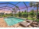 Private screened-in pool area with a sun shelf and comfortable lounge chairs at 17910 Waterville Pl, Lakewood Ranch, FL 34202