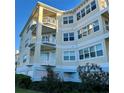 Multi-story building with large windows and multiple balconies, surrounded by greenery at 3418 79Th Street W Cir # 202, Bradenton, FL 34209