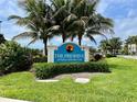 Community sign at The Preserve At Palma Sola Bay Club surrounded by lush landscaping at 3418 79Th Street W Cir # 202, Bradenton, FL 34209