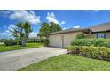 Attached two-car garage with a paved driveway, providing ample parking and convenient access to the home at 3734 Ballantrae Dr # 19D, Sarasota, FL 34238