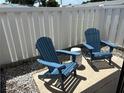 Enjoy outdoor relaxation on this private patio with comfortable blue Adirondack chairs at 3703 39Th Street W # 11, Bradenton, FL 34205