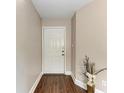 Clean entryway features wood floors, white trim, and a decorative floral arrangement at 4057 Crockers Lake Blvd # 15, Sarasota, FL 34238